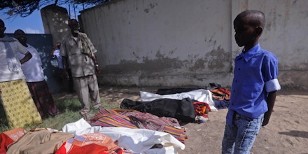 Relatives gather to look at the dead bodies of ten people including children after a raid on their farms in Bariire, some 50 km west of Mogadishu, on August 25, 2017.Somali officials said Friday they had killed eight jihadist fighters during an overnight operation, denying claims from local elders that they had shot civilians dead, two of them children. Somali community leaders accused the troops, accompanied by US military advisors, of having killed the nine civilians in the overnight operations. An initial government statement said its troops had come under fire from jihadists while on patrol, insisting that no civilians had been killed. A later statement acknowledged that there had been civilian casualties, in what the government seemed to suggest was a separate incident. They did not say who was responsible. / AFP PHOTO / Mohamed ABDIWAHAB (Photo credit should read MOHAMED ABDIWAHAB/AFP via Getty Images)