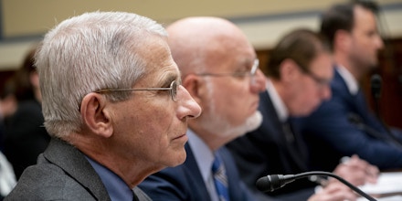 Anthony Fauci, director of the National Institute of Allergy and Infectious Diseases, left, and Robert Redfield, director of the Centers for Disease Control and Prevention (CDC), center, listen during a House Oversight Committee hearing in Washington, D.C., U.S., on Wednesday, March 11, 2020. The U.S. has shifted into a new phase of its coronavirus response after efforts to stamp out sparks of an outbreak have failed. Authorities now are focusing on limiting damage. Photographer: Andrew Harrer/Bloomberg via Getty Images