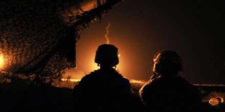 US Marines from C company 1/6 24 MEU stand alert as colleagues open fire on a Taliban target in Garmser in south of Helmand Province on May 5, 2008.   Helmand, the main source of Afghanistan's opium output, is in the grip of a Taliban-insurgency launched after it was toppled from government in a US-led invasion in late 2001. Most ISAF soldiers in Helmand are British, and were joined by US Marines last week in a push to remove the Taliban from around southern Garmser district.         AFP PHOTO/Massoud HOSSAINI (Photo credit should read MASSOUD HOSSAINI/AFP via Getty Images)
