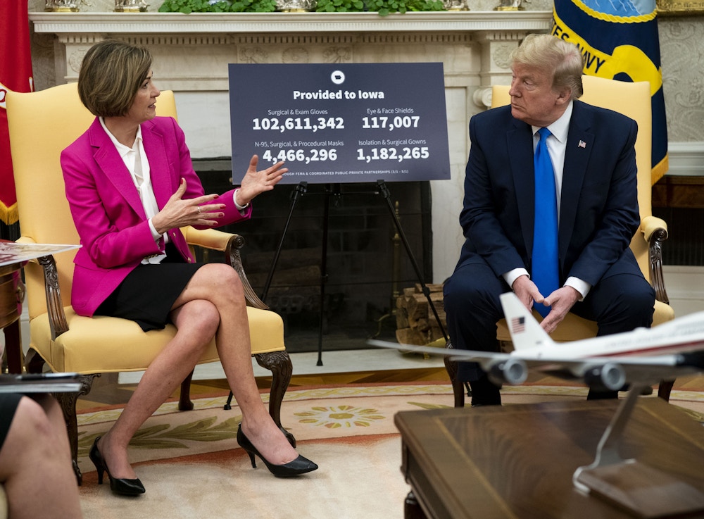 U.S. President Donald Trump listens as Kim Reynolds, governor of Iowa, left, speaks during a meeting in the Oval Office of the White House in Washington, D.C., U.S., on Wednesday, May 6, 2020. Trump fixed his course on reopening the nation for business, acknowledging that the move would cause more illness and death from the pandemic but insisting it's a cost he's willing to pay to get the economy back on track. Photographer: Doug Mills/The New York Times/Bloomberg
