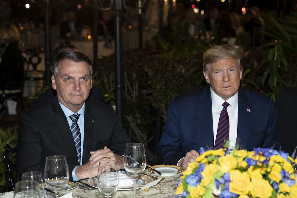 FILE - In this March 7, 2020, file photo President Donald Trump is seated before a dinner with Brazilian President Jair Bolsonaro, left, at Mar-a-Lago in Palm Beach, Fla. Bolsonaro’s communications director, Fábio Wajngarten, tested positive just days after traveling with Bolsonaro to a meeting with Trump and senior aides in Florida. (AP Photo/Alex Brandon, File)