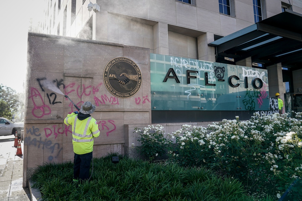 WASHINGTON, DC - JUNE 01: Workers clean graffiti off of an entrance sign to the AFL-CIO headquarters that was vandalized during overnight unrest, June 1, 2020 in Washington, DC. Protests and riots continue across American following the death of George Floyd, who died after being restrained by Minneapolis police officer Derek Chauvin. Chauvin, 44, was charged last Friday with third-degree murder and second-degree manslaughter. (Photo by Drew Angerer/Getty Images)