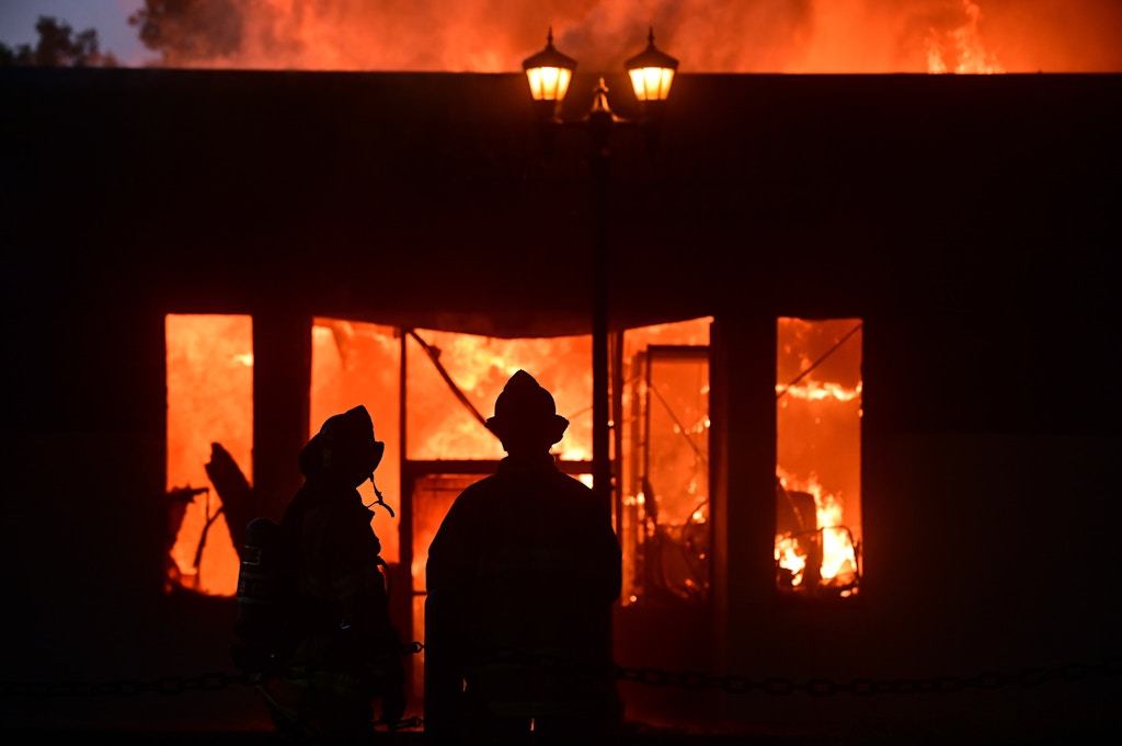 ST. PAUL, MINNESOTA -- Firefighters watch as flames devour a building on University Ave. and Syndicate St. in St. Paul's Midway neighborhood Thursday, May 28, 2020, following the Monday death of George Floyd while in police custody in Minneapolis. (John Autey / MediaNews Group / St. Paul Pioneer Press via Getty Images)