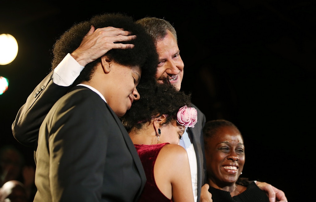 NEW YORK, NY - SEPTEMBER 11:  Democratic candidate for Mayor Bill de Blasio (Top, C), son Dante (L), daughter Chiara (Bottom, C) and wife Chirlane McCray (Bottom, R) celebrate at his primary night party on September 11, 2013 in the Brooklyn borough of New York City.  De Blasio is leading the Democratic race, according to exit polls.  (Photo by Mario Tama/Getty Images)
