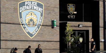 Police officers stand in front of the 47th precinct, near the scene of a fatal shooting of a New York City police officer in the Bronx borough of New York, Sunday, Sept. 29, 2019.  (AP Photo/Seth Wenig)