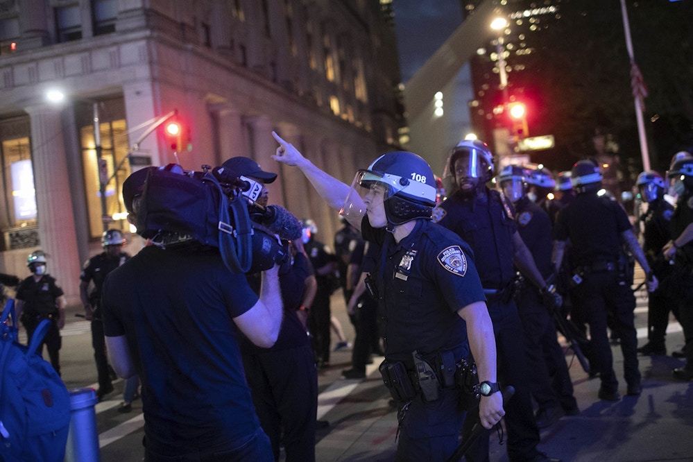 A police officer shouts at Associated Press videojournalist Robert Bumsted, Tuesday, June 2, 2020, in New York. New York City police officers surrounded, shoved and yelled expletives at two Associated Press journalists covering protests Tuesday in the latest aggression against members of the media during a week of unrest around the country. Portions of the incident were captured on video by Bumsted, who was working with photographer Wong Maye-E to document the protests in lower Manhattan over the killing of George Floyd in Minneapolis. (AP Photo/Wong Maye-E)