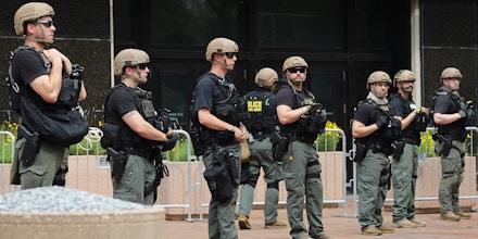 WASHINGTON, DC - JUNE 06: FBI officers stand guard at the J. Edgar Hoover Building during a protest against police brutality and racism on June 6, 2020 in Washington, DC. This is the 12th day of protests with people descending on the city to peacefully demonstrate in the wake of the death of George Floyd, a black man who was killed in police custody in Minneapolis on May 25. (Photo by Chip Somodevilla/Getty Images)