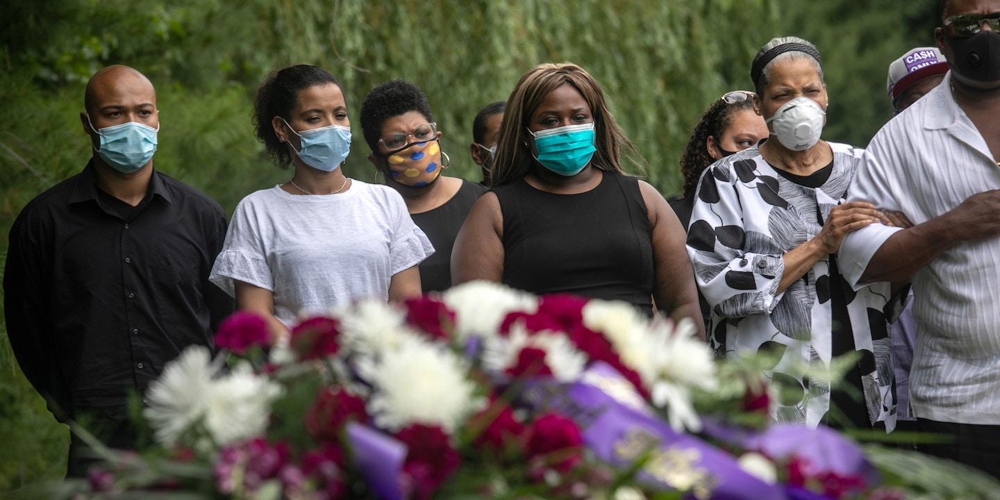 RYE, NEW YORK - JULY 03: Family and friends attend the burial of Conrad Coleman Jr. on July 03, 2020 in Rye, New York. Conrad Coleman Jr, 39, died of Covid-19 on June 20, 2020, just over two months after his father Conrad Coleman Sr. also died of the disease. The funeral service was held in Coleman's nearby hometown of New Rochelle, New York, an early epicenter of the coronavirus pandemic in the eastern United States. The African American community has been especially hard-hit by coronavirus pandemic, both in terms of illnesses and deaths. (Photo by John Moore/Getty Images)