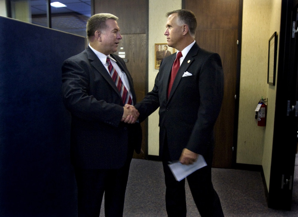 Newly elected Speaker of the North Carolina House of Rep. Thom Tillis, right, and newly elected Majority Leader Rep. Paul Stam, left, catch a quick moment together before leaving after a caucus, Saturday, Nov. 20, 2010, in Raleigh, N.C. Members of the Republican Caucus held named Tillis the new Speaker of the House and Stam the majority leader, among several positions they addressed. (AP Photo/News & Observer, Corey Lowenstein)