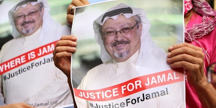 WASHINGTON, USA - OCTOBER 10: A member of the Organization 'Justice for Jamal Khashoggi' holds a picture of Khashoggi as she and other members hold news conference for disappearance of Saudi journalist in front of The Washington Post headquarters in Washington D.C. with the attendance of Congressman Gerry Connolly and figures from CAIR and Pen America spoke, in Washington D.C., United States on October 10, 2018. (Photo by Umar Farooq/Anadolu Agency/Getty Images)