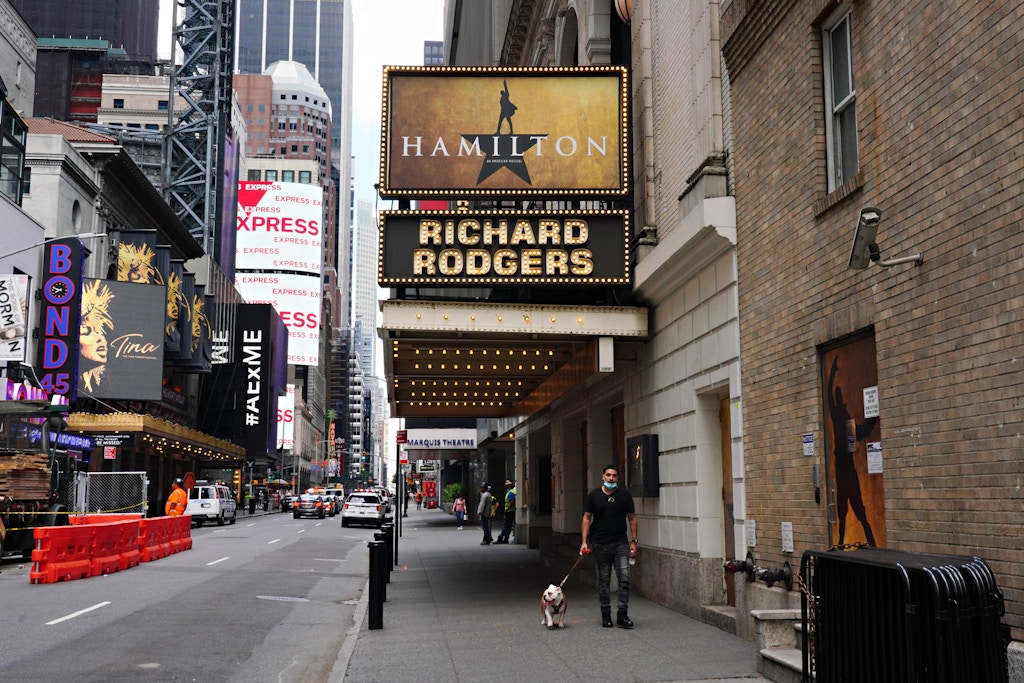 NEW YORK, NEW YORK - JUNE 29: A person walks a dog under the marquee of Hamilton: An American Musical at the Richard Rodgers Theatre on June 29, 2020 in New York City.  Broadway will remain closed until 2021 due to the ongoing coronavirus pandemic. (Photo by Cindy Ord/Getty Images)