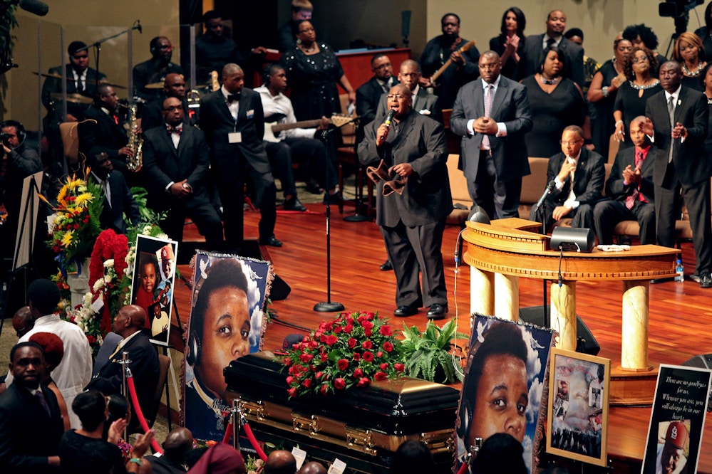 Pictures of Michael Brown flank his casket during his funeral, Monday, Aug. 25, 2014, at Friendly Temple Missionary Baptist Church in St. Louis. Hundreds of people gathered to say goodbye to Brown, who was shot and killed by a Ferguson, Mo., police officer on Aug. 9. The more than two weeks since Brown's death have been marked by nightly protests, some violent and chaotic, although tensions have eased in recent days. (AP Photo/St. Louis Post Dispatch, Robert Cohen, Pool)
