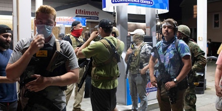 Armed civilians outside of a gas station during unrest in Kenosha, Wisconsin, August 25, 2020.