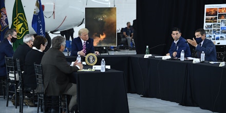 Wade Crowfoot(R), Secretary, California Natural Resources Agency speaks to US President Donald Trump(L) during a briefing on wildfires with local and federal fire and emergency officials at Sacramento McClellan Airport in McClellan Park, California on September 14, 2020. (Photo by Brendan Smialowski / AFP) (Photo by BRENDAN SMIALOWSKI/AFP via Getty Images)