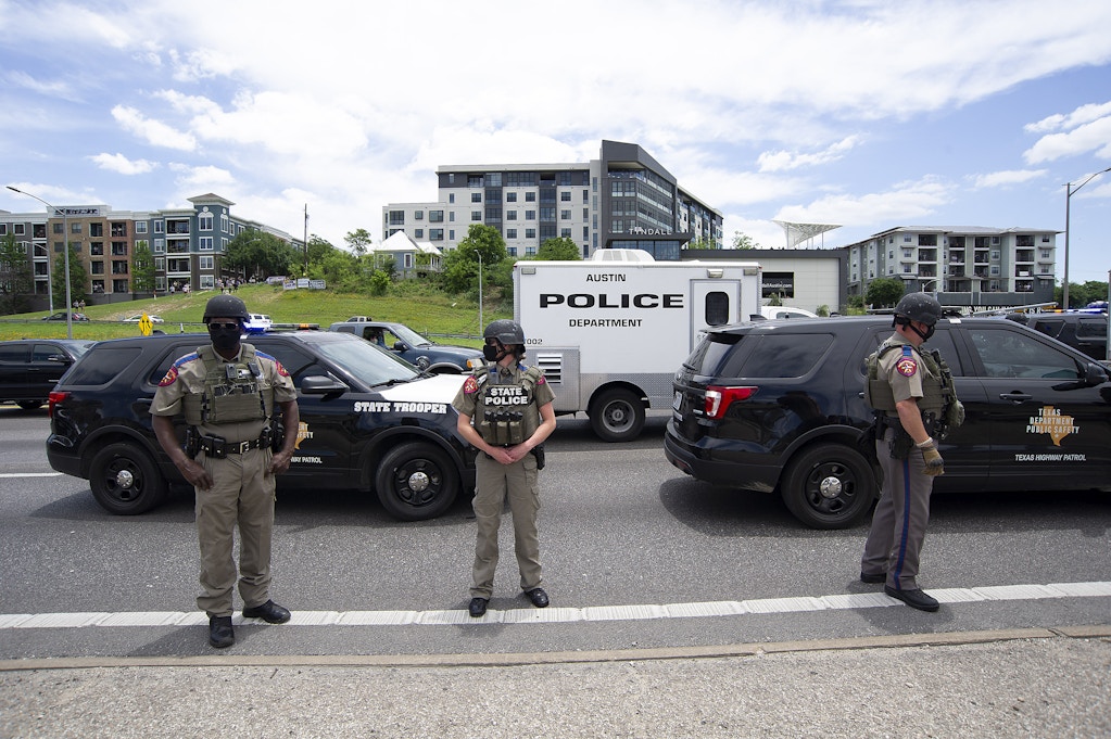 Texas Department of Public Safety State Police stand at attention on Interstate 35 during the Mike Ramos protest, A month ago Mike Ramos died after an officer fired his rifle at him on May 3, 2020.