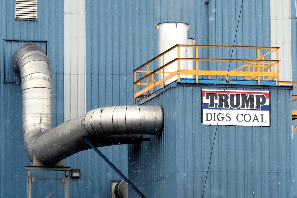 A sign with the words "Trump digs coal" can be seen on a factory building .