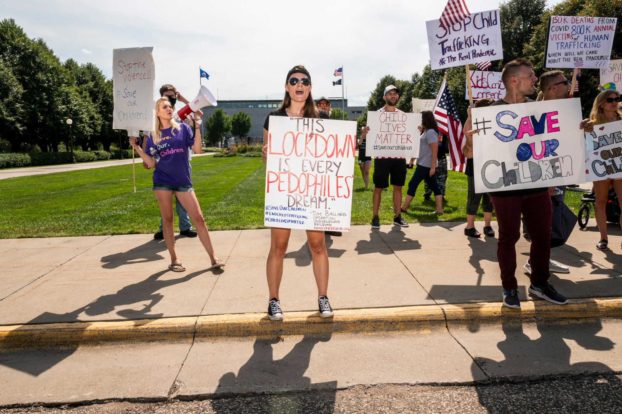 People march during a "Save the Children" rally outside the Capitol building on August 22, 2020 in St Paul, Minnesota.