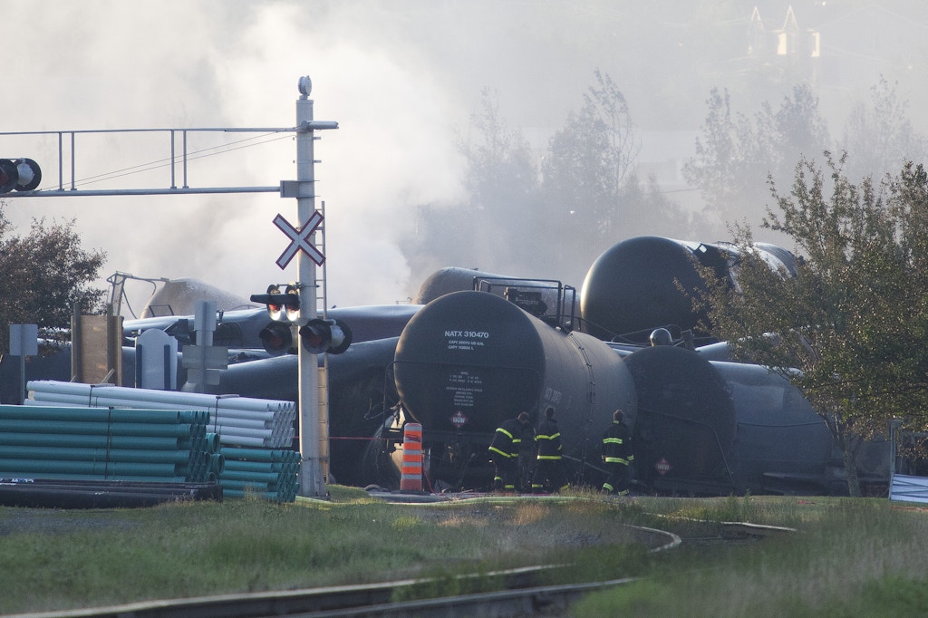 Firefighters inspect the wreckage on July 7, 2013 of a freight train loaded with oil that derailed July 6 in Lac-Megantic in Canada's Quebec province, sparking explosions that engulfed about 30 buildings in a wall of fire.