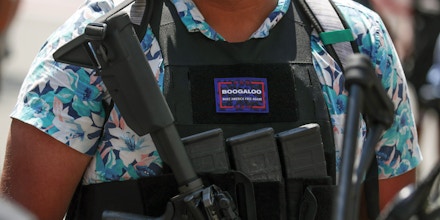 An armed protester wearing a Hawaiian shirt and a Boogaloo badge takes part in a rally for Second Amendment gun rights near the Virginia State Capitol in Richmond, Virginia, on July 4, 2020.