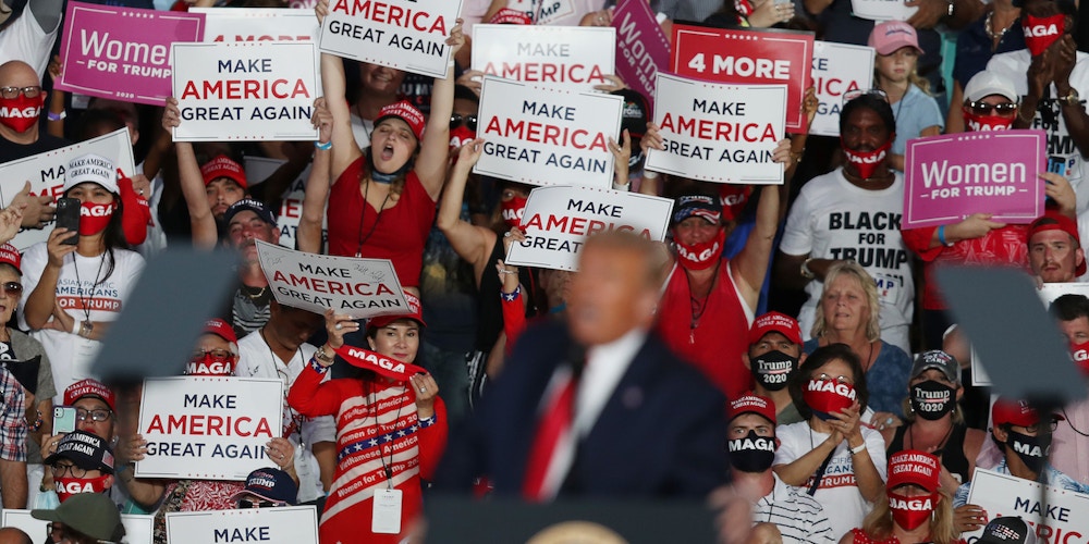 SANFORD, FLORIDA - OCTOBER 12:  People cheer as President Donald Trump speaks during his campaign event at the Orlando Sanford International Airport on October 12, 2020 in Sanford, Florida.  Trump was holding his first campaign rally since his coronavirus diagnosis as he continues to campaign against Democratic presidential candidate Joe Biden.  (Photo by Joe Raedle/Getty Images)