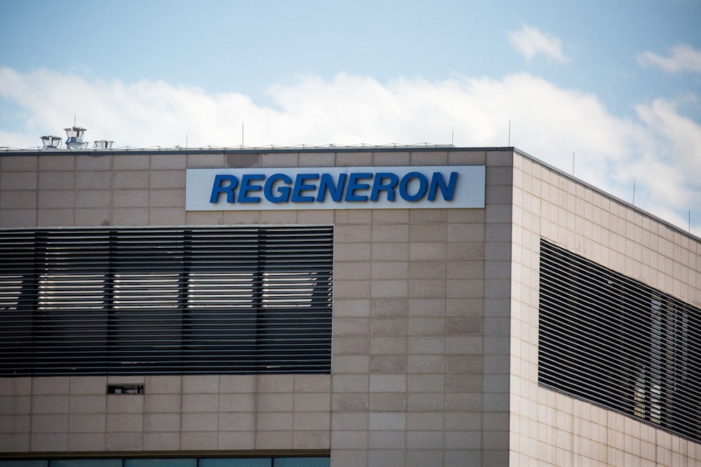 Regeneron Pharmaceuticals Inc. signage is displayed outside their headquarters in Tarrytown, N.Y., U.S., on June 12, 2020. Regeneron Pharmaceuticals Inc. said it had begun human trials of a new antibody cocktail for Covid-19, part of an ambitious clinical-testing plan that could lead to a new treatment option by the end of summer if all goes well. Photographer: Michael Nagle/Bloomberg via Getty Images