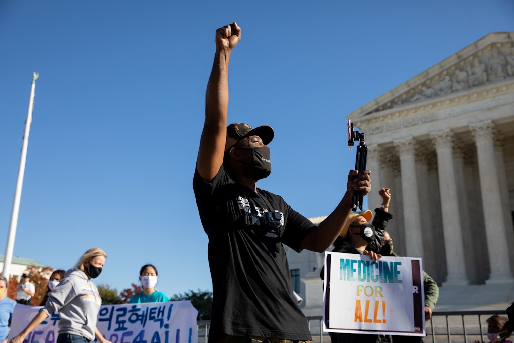 A demonstrator raises his fist outside of the U.S. Supreme Court in Washington, D.C., U.S., on Nov. 10, 2020.