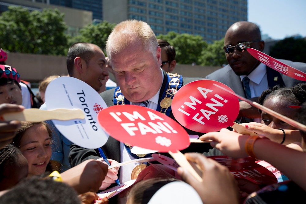 TORONTO, ON - JULY 11  -  Toronto Mayor Rob Ford signs autographs for kids after the official launch of Toronto 2015 Pan Am Games, marking one year to go, at Nathan Phillips Square on July 11, 2014.        (Carlos Osorio/Toronto Star via Getty Images)