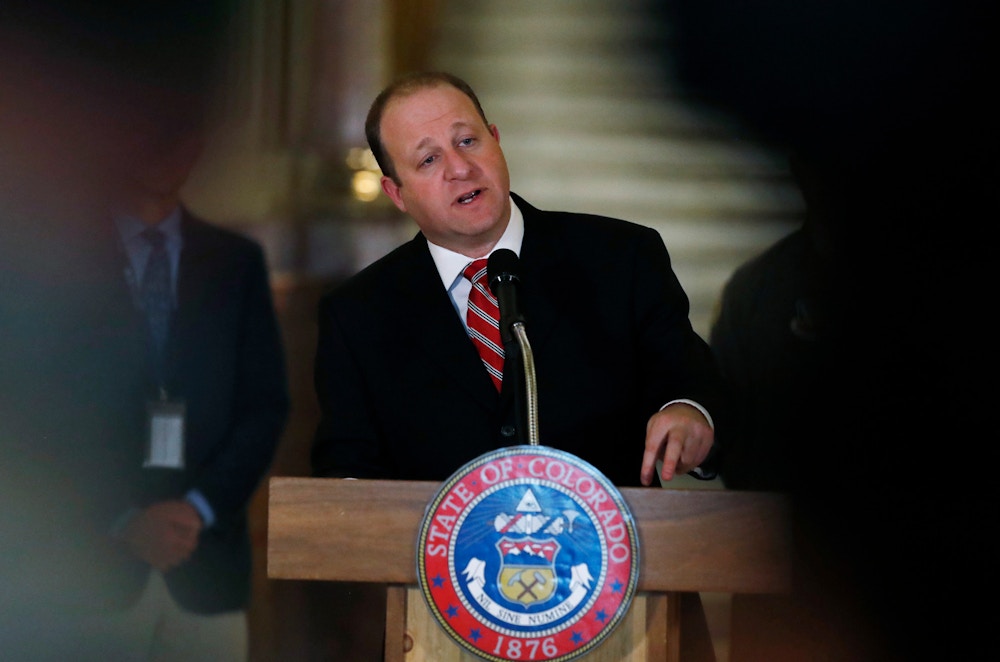 In this Monday, March 16, 2020, photograph, Colorado Gov. Jared Polis makes a point during a news conference about the state's efforts to fend off the spread of coronavirus in the Centennial State. On Monday, March 23, Polis signed a bill to abolish the death penalty and reduce the terms to life in prison for Colorado's three, death-row inmates. (AP Photo/David Zalubowski)