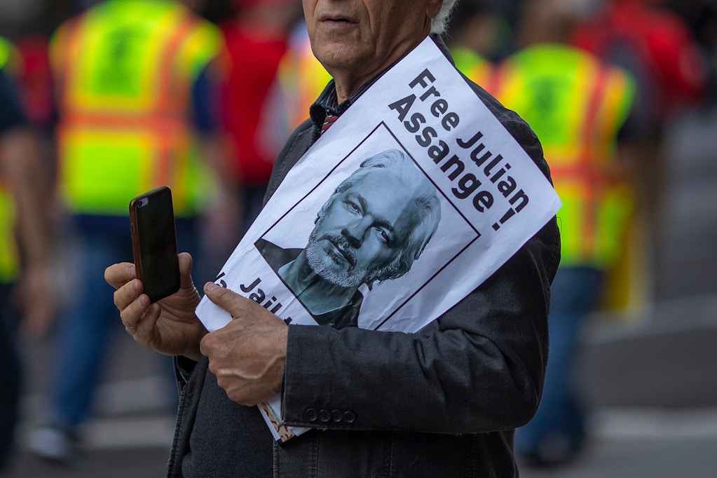 LOS ANGELES, CA - MAY 01: A man holds a sign calling for the release of Julian Assange as people march and rally on May Day, also known as International Workers Day, on May 1, 2019 in Los Angeles, California. People are participating in multiple May Day marches and rallies around Los Angeles, calling for support of labor and immigrant concerns such as wage improvement, immigration reform and a citizenship question in the upcoming national census.  (Photo by David McNew/Getty Images)