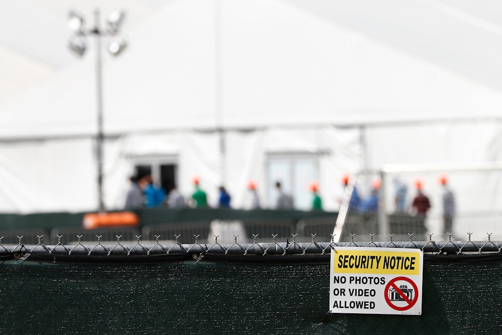 Migrant children who have been separated from their families can be seen in tents at a detention center in Homestead, Florida on June 27, 2019. - Public outcry over Trump's handling of the border crisis has increased dramatically after a migrant rights group revealed alarming detention conditions of migrant children in Texas, where children were deprived of showers and clean clothes for weeks. (Photo by RHONA WISE / AFP)        (Photo credit should read RHONA WISE/AFP via Getty Images)