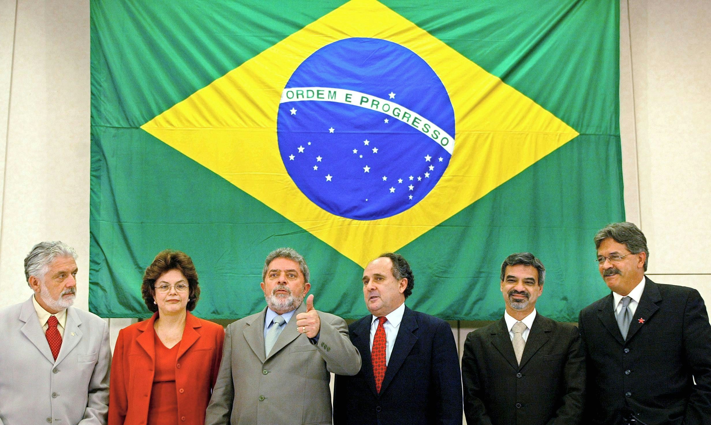 Luiz Inacio Lula da Silva (3rd L), president-elect of Brazil, gives the thumbs-up 20 December, 2002 in Sao Paulo, Brazil, as he presents his ministers (from L-R): Minister of work Jacques Wagner, Energy minister Dilma Rousseff, Education minister Cristovao Buarque, Health minister Humberto Costa and national secretary of Human Rights Nilmario Miranda. AFP PHOTO/Mauricio LIMA (Photo credit should read MAURICIO LIMA/AFP via Getty Images)