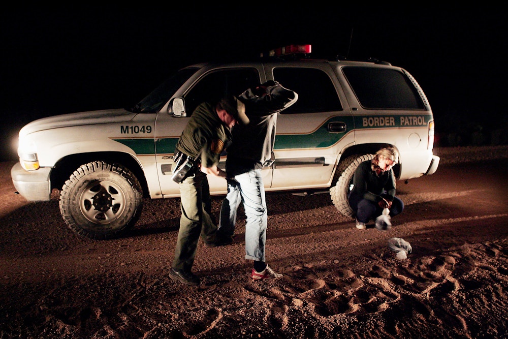 DOUGLAS, AZ - APRIL 4:  Border Control Agent Jason Huberd searches migrants captured near the border April 4, 2005 near Douglas, Arizona. Illegal immigration in the region has slowed over the past few days, partly due to the presence of volunteers from the Minuteman Project. The projects participants are expected to fan out across a 23 mile stretch on the Arizona side of the border to search for Illegal aliens who are making the trek into the U.S. from Mexico. (Photo by Scott Olson/Getty Images)