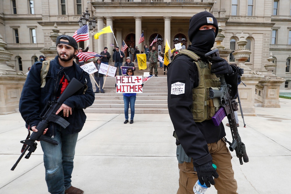FILE - In this April 15, 2020, file photo, protesters carry rifles near the steps of the Michigan State Capitol building in Lansing, Mich.  When President Trump-supporting insurrectionists stormed the U.S. Capitol in an attempt to overturn the presidential election on Wednesday, Jan. 6 2021 the nation was shocked, but not unwarned. A series of dress rehearsals of sorts have played out in statehouses in Michigan, Oregon, Idaho and elsewhere in recent months, with armed protesters forcing their way into buildings. (AP Photo/Paul Sancya, File)