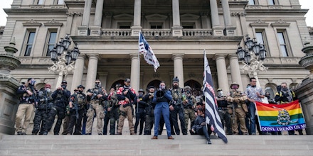 Armed anti-government extremists who call themselves “boogaloo bois” hold a rally at Michigan State Capitol on Oct. 17, 2020, in Lansing, Mich.