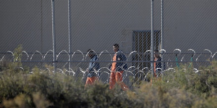 Migrants housed at the Otero County Processing Center walk through the yard in October 2019.