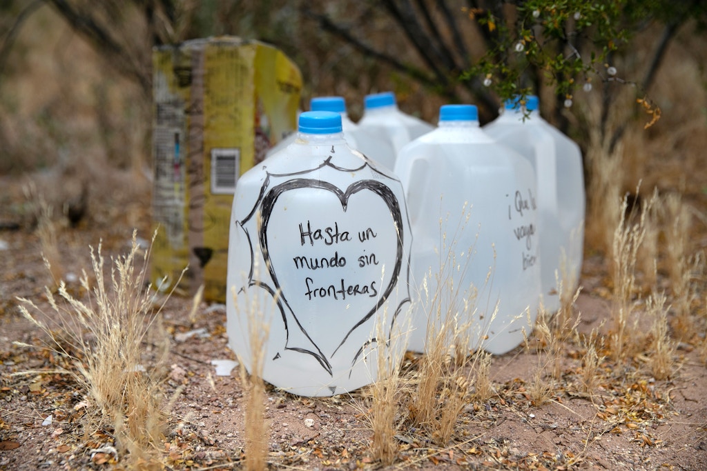 AJO, ARIZONA - MAY 10: Jugs of water for undocumented immigrants sits along migrant trails after being delivered by volunteers for the humanitarian aid group No More Deaths on May 10, 2019 near Ajo, Arizona. The volunteers distributed the aid along trails in remote areas immigrants pass after crossing the border from Mexico. The number of immigrant deaths, mostly due to dehydration and exposure, has risen as higher border security in urban border areas has pushed immigrant crossing routes into more remote desert regions. No More Deaths volunteer Scott Warren is scheduled to appear in federal court on May 29 in Tucson, charged by the U.S. government on two counts of harboring and one count of conspiracy for aiding two Central American immigrants in January, 2018. If found guilty Warren could face up to 20 years in prison. The trial is seen as a watershed case by the Trump Administration, as it pressures humanitarian organizations working to reduce suffering and deaths of immigrants in remote areas along the border. The government claims the aid encourages human smuggling. In a separate misdemeanor case, federal prosecutors have charged Warren with abandonment of property, for distributing food and water along migrant trails. (Photo by John Moore/Getty Images)