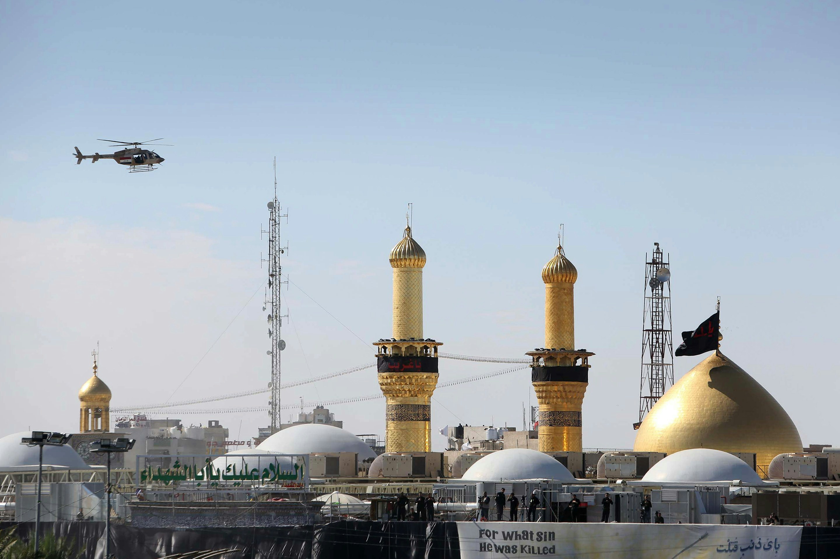 An helicopter flies over the shrine of Imam Hussein during the Ashura commemorations that mark his killing on November 4, 2014 in the central city of Karbala, Iraq.