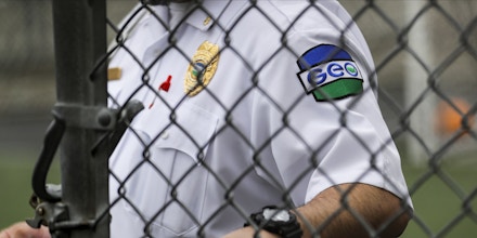 A patch is shown on the uniform of a guard with the GEO Group, Inc., during a media tour of the U.S. Immigration and Customs Enforcement detention center, Monday, Dec. 16, 2019, in Tacoma, Wash. The GEO Group is the private company that operates the center for the U.S. Government. (AP Photo/Ted S. Warren)