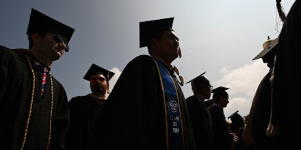 Students wearing academic regalia attend their graduation ceremony at the University of California Los Angeles, on June 14, 2019 in Los Angeles California.