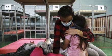 Ana Maria Moreno Portillo from Guatemala embraces her daughter after they were deported from the U.S., at the Kiki Romero Sports Complex in Ciudad Juarez, Mexico, Monday, April 5, 2021. The sports complex was adapted as a shelter because of the growing number of migrants being deported daily. (AP Photo/Christian Chavez)