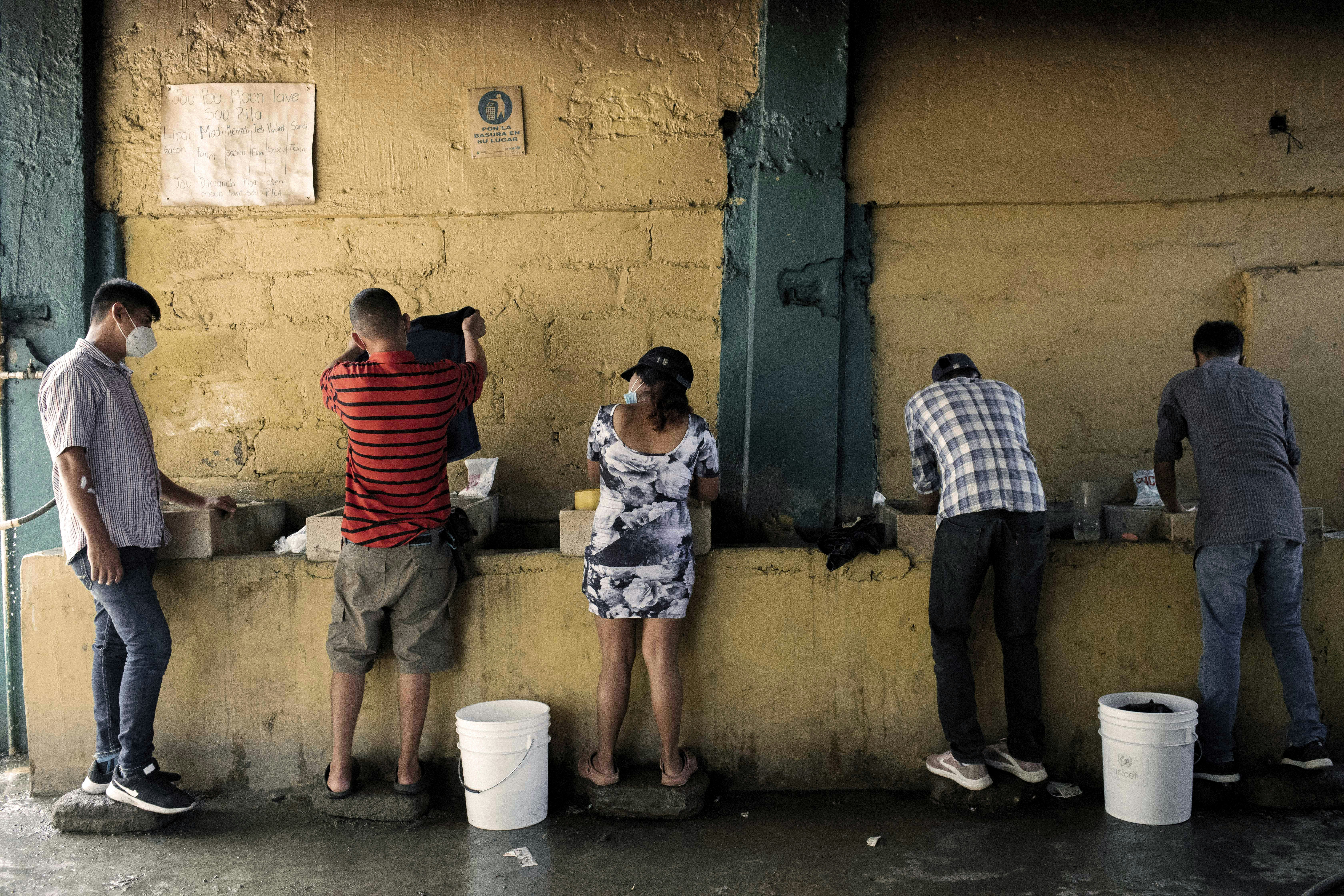 Migrants and asylum seekers wash clothing at a shelter in Tapachula, Chiapas state, Mexico, on Friday, Jan. 29, 2021. U.S. President Joe Biden and Mexican President Andres Manuel Lopez Obrador agreed to work together to stem the flow of irregular migration to their countries, the White House said. Photographer: Nicolo Filippo Rosso/Bloomberg via Getty Images