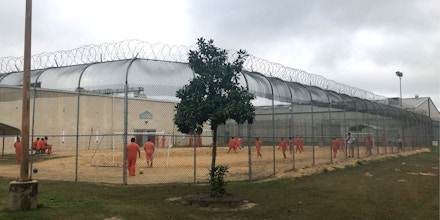 Detained immigrants play soccer behind a barbed wire fence at the Irwin County Detention Center in Ocilla, Georgia in February 20, 2018.