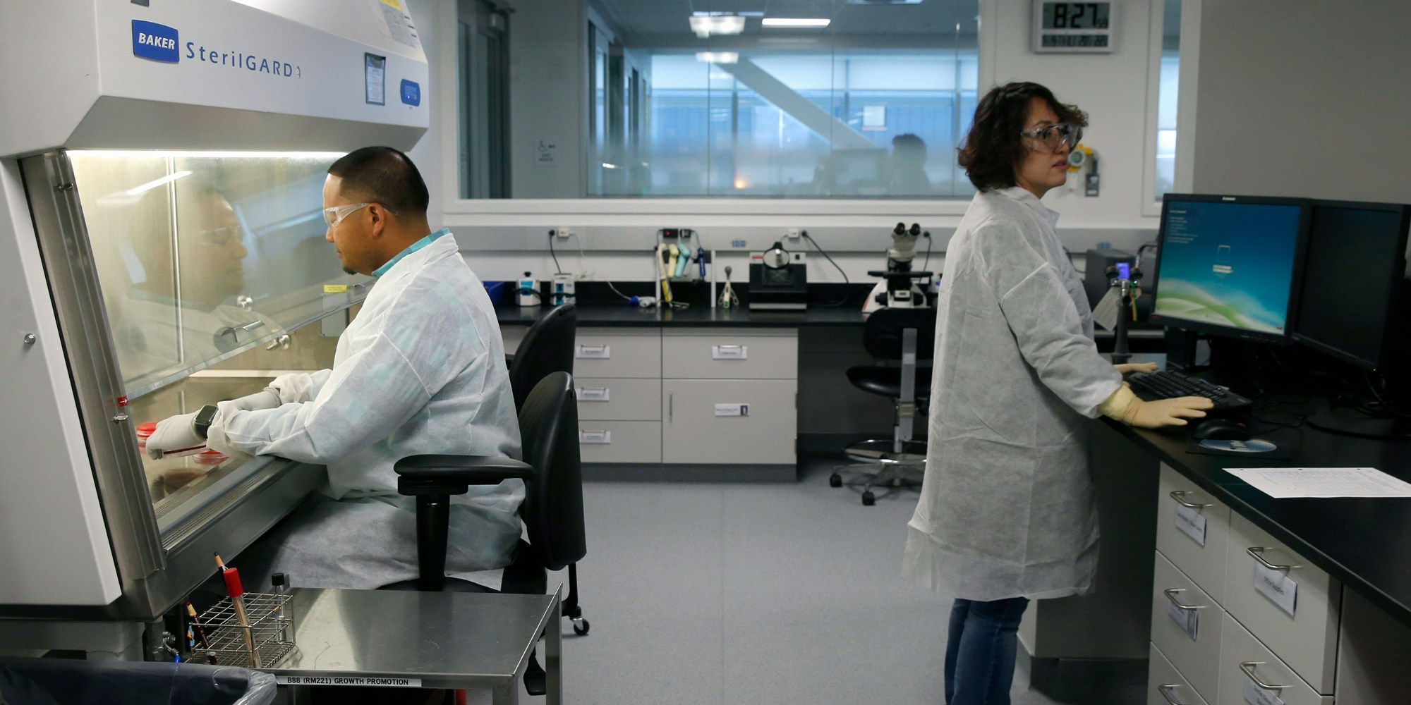 Markus Punsulan and Sol Nho work inside one of the labs at the Bayer pharmaceutical and biotech campus in Berkeley, Calif. on Thursday, May 9, 2019. Bayer is breaking ground on its Cell Culture Technology Center. (Photo by Paul Chinn/San Francisco Chronicle via Getty Images)