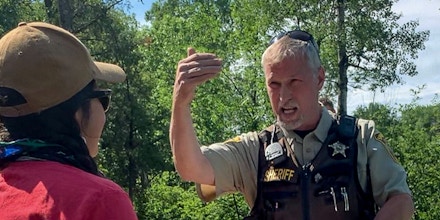An officer with the Hubbard County Sheriff’s Office argues with activist Tara Houska on June 28, 2021.