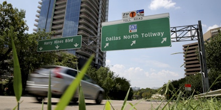 A sign points the way for drivers to a enter a toll road in Dallas, Thursday, Aug. 10, 2017. Officials this week have eliminated a toll highway in West Texas and quashed efforts to build one in Dallas. Meanwhile, tolls will no longer be collected on a South Texas highway starting next month. Texas appears to be bucking, at least temporarily, a national trend of states turning regularly to tolls as a way to fund long-standing transportation needs. (AP Photo/LM Otero)