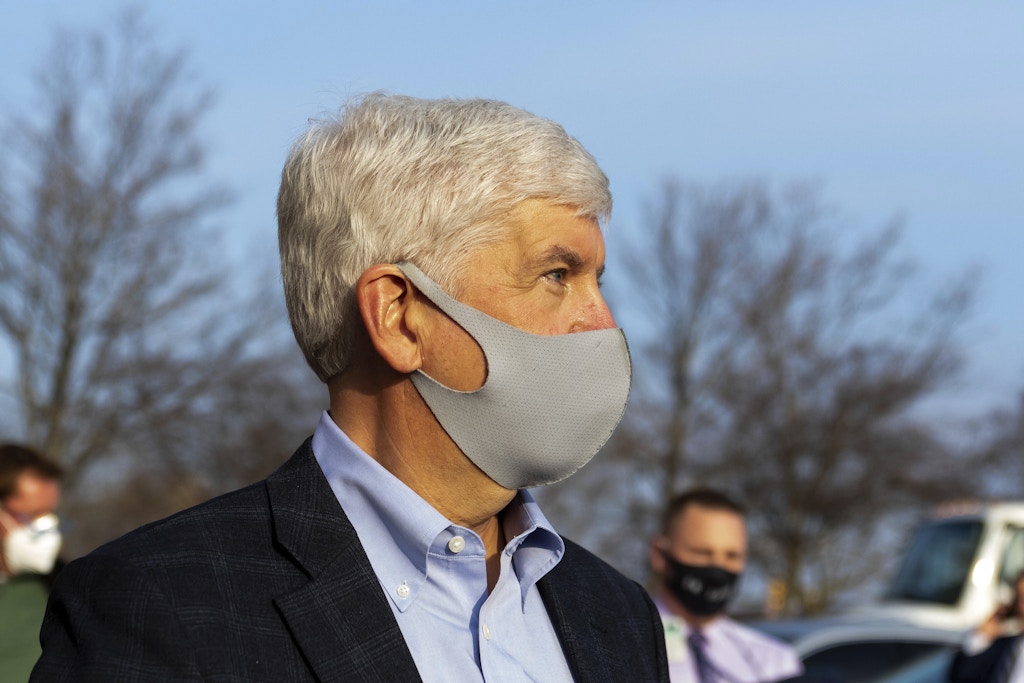 Former Gov. Rick Snyder stays silent as barrage of media asks questions after his video arraignment on charges related to the Flint water crisis, Thursday, Jan. 14, 2021 outside the Genesee County Jail in downtown Flint, Mich. (Cody Scanlan/The Flint Journal via AP)