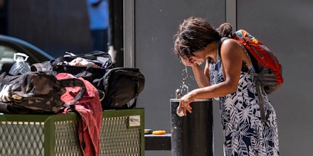 A resident splashes water onto their face during a heatwave in Sacramento, California, U.S., on Thursday, July 8, 2021. Another round of wilting heat bearing down on the U.S. West will put further pressure on electric grids and raise fire risks across the region before reaching a peak by weeks end. Photographer: David Paul Morris/Bloomberg via Getty Images