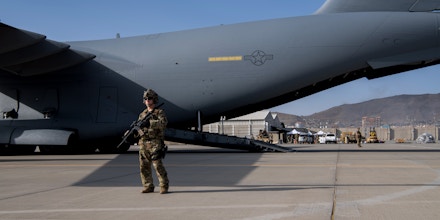 A U.S. Air Force security forces raven, assigned to the 816th Expeditionary Airlift Squadron, maintain a security cordon around a U.S. Air Force C-17 Globemaster III aircraft in support of the Afghanistan evacuation at Hamid Karzai International Airport (HKIA), Afghanistan, Aug. 24, 2021. (U.S. Air Force photo by Master Sgt. Donald R. Allen)