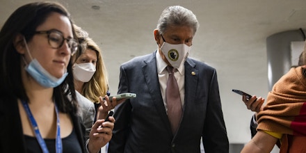 U.S. Sen. Joe Manchin (D-WV) is surrounded by reporters as he walks through the basement of the U.S. Capitol Building on August 10, 2021 in Washington, DC.