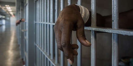 A prisoner’s hand inside a punishment cell wing at Louisiana State Penitentiary on Oct. 14, 2013.